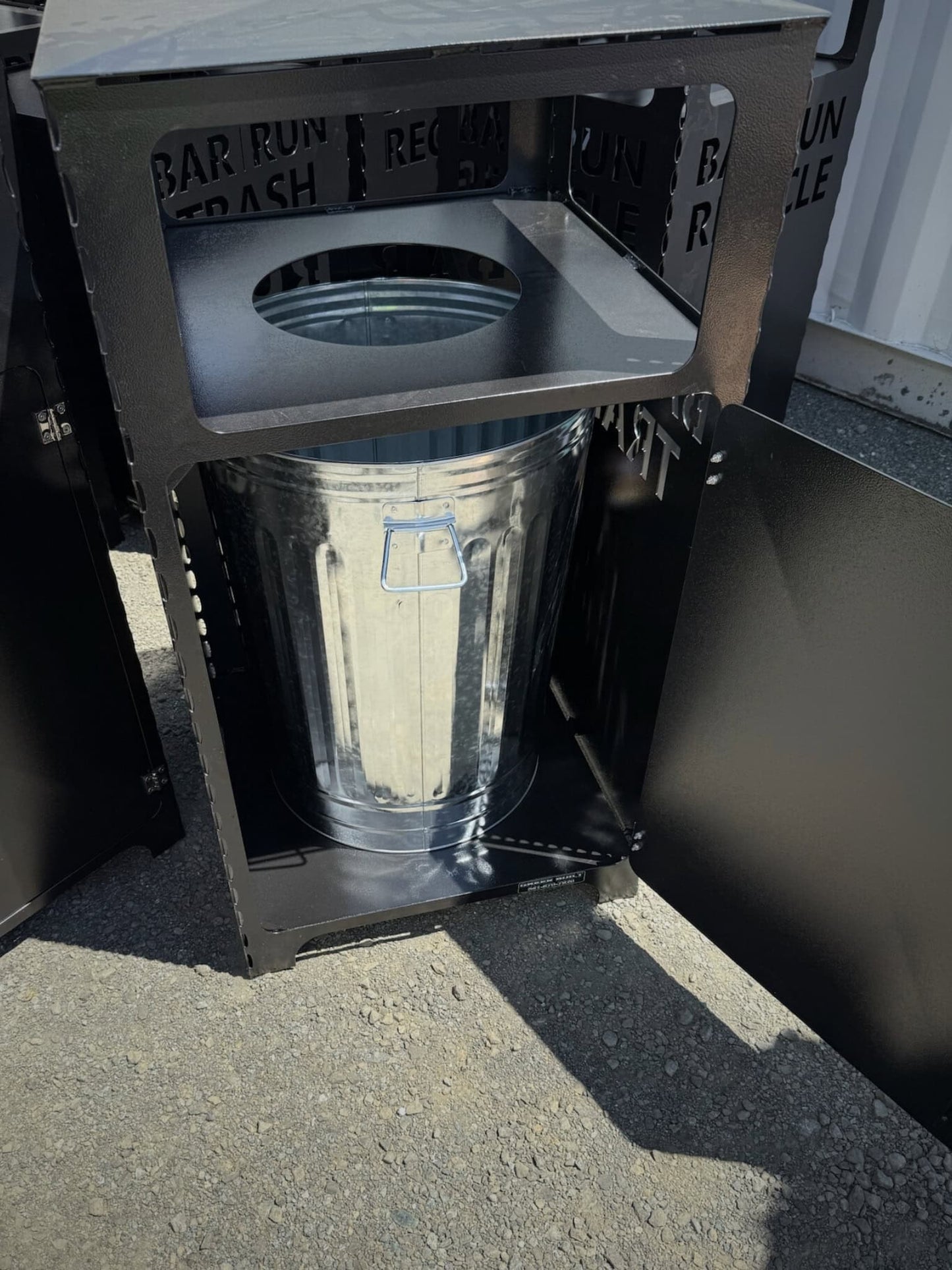 30 Gallon covered trash can opened to show inside