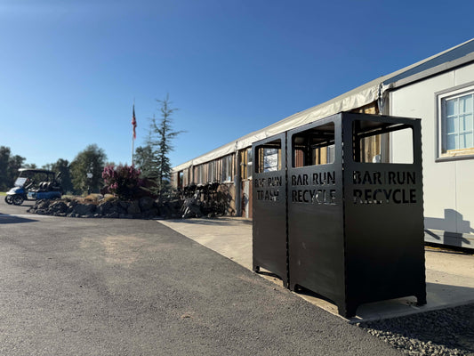 Customized train and recycling bin in front of golf course office.