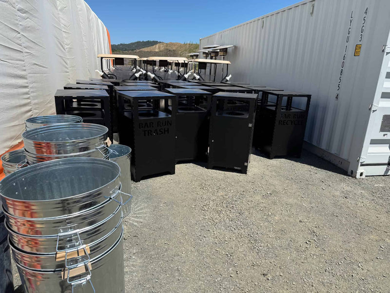 Heavy duty trash and recycling bins waiting to be installed on commercial golf course