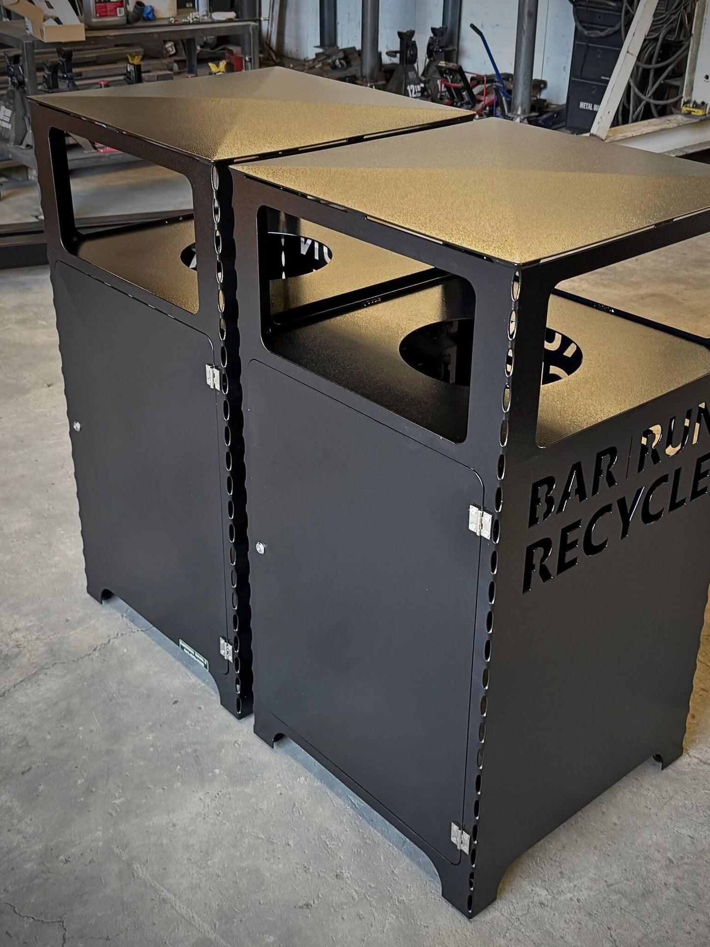 Powder coated metal trash and recycling bin on Fab shop floor.