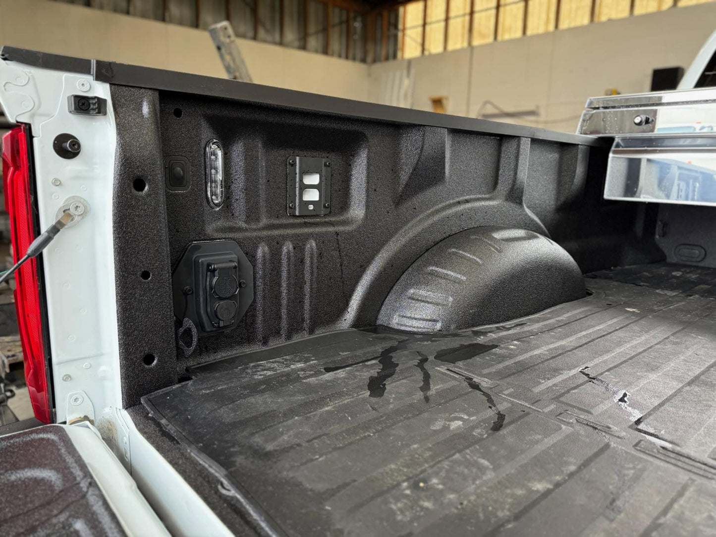 Close-up of a king ranch ford truck bed with a black metal bracket