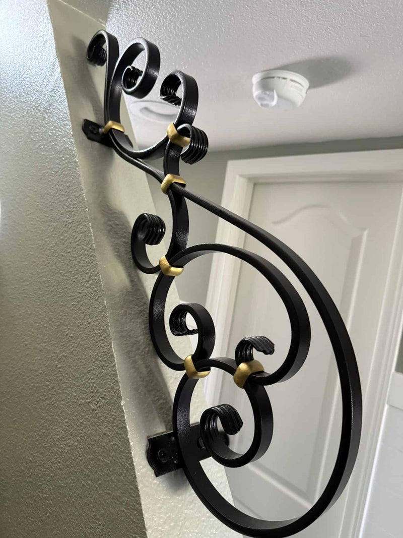 Custom metal artwork on wall by stairs that matched residential project for client