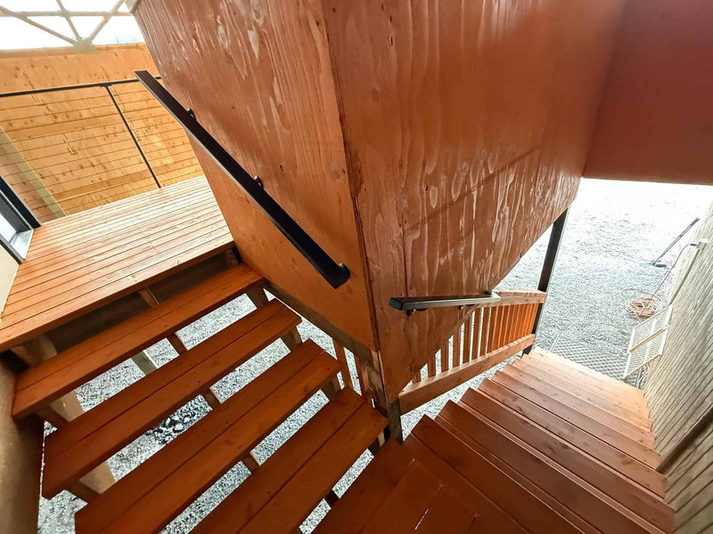 Metal Hand guide rails on wood deck stairs