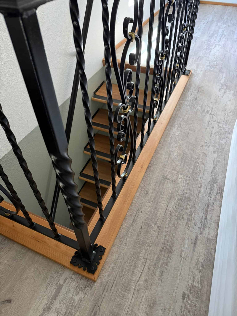 Ornate baluster and railing overlooking stairs in master bedroom