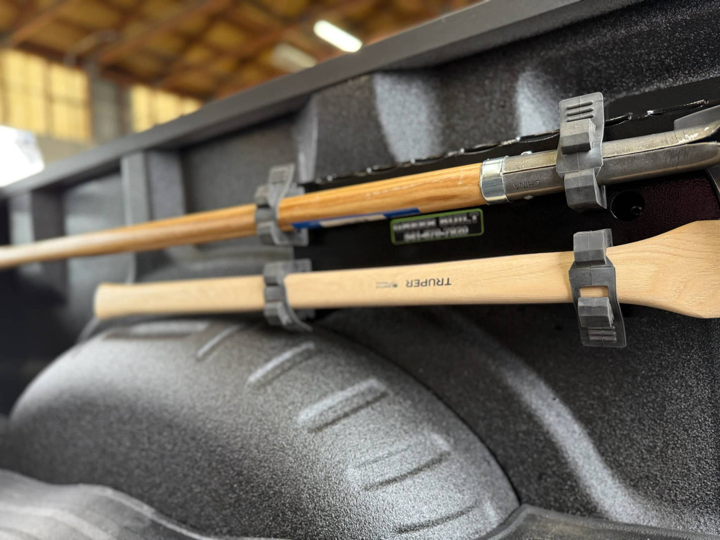 Fire tools held in place with quick release tool mount in the back of a ford king ranch truck.