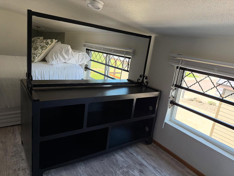 Metal framed mirror and bookshelf in a nice master bedroom