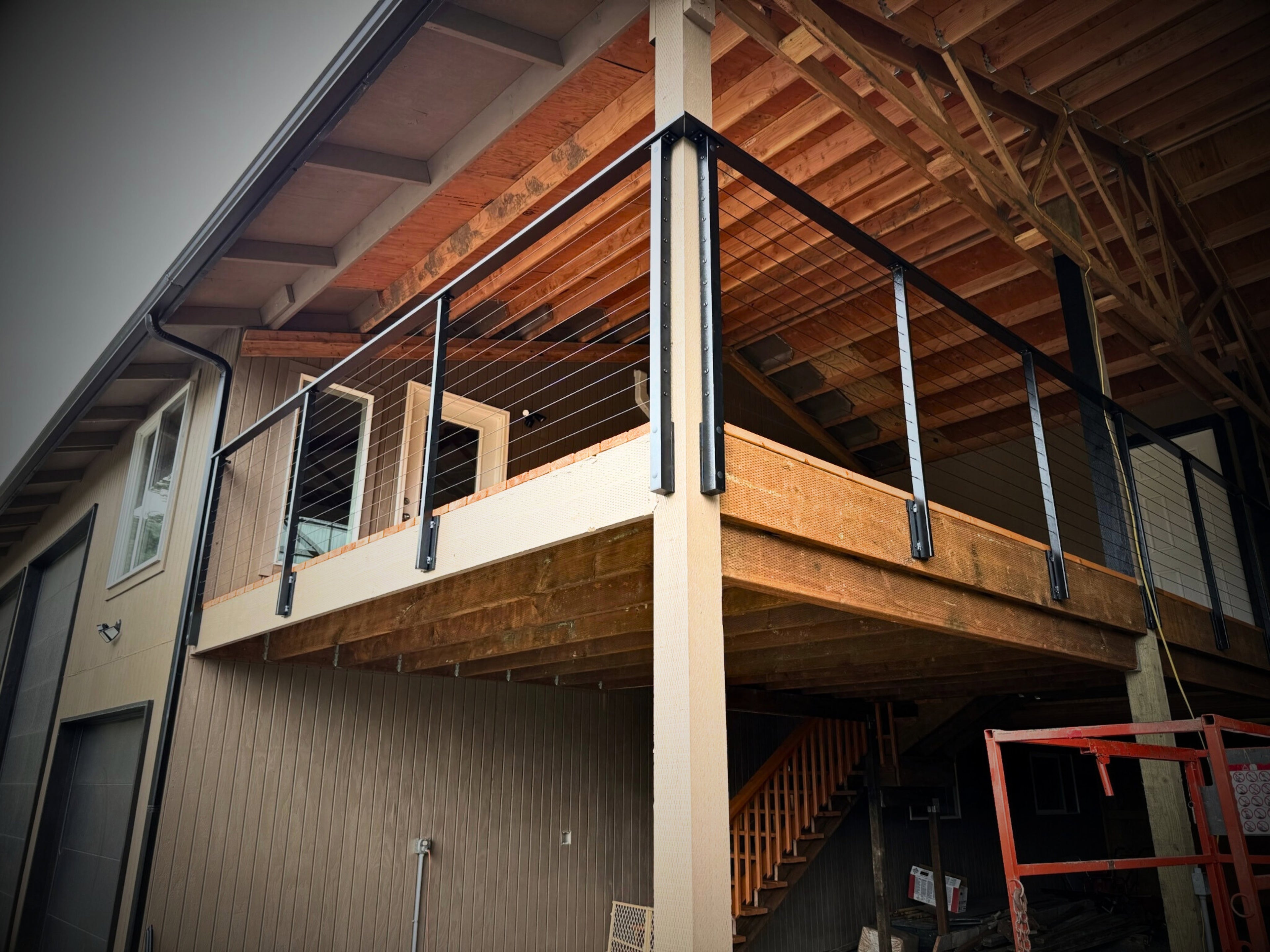 Black custom handrail on wood deck