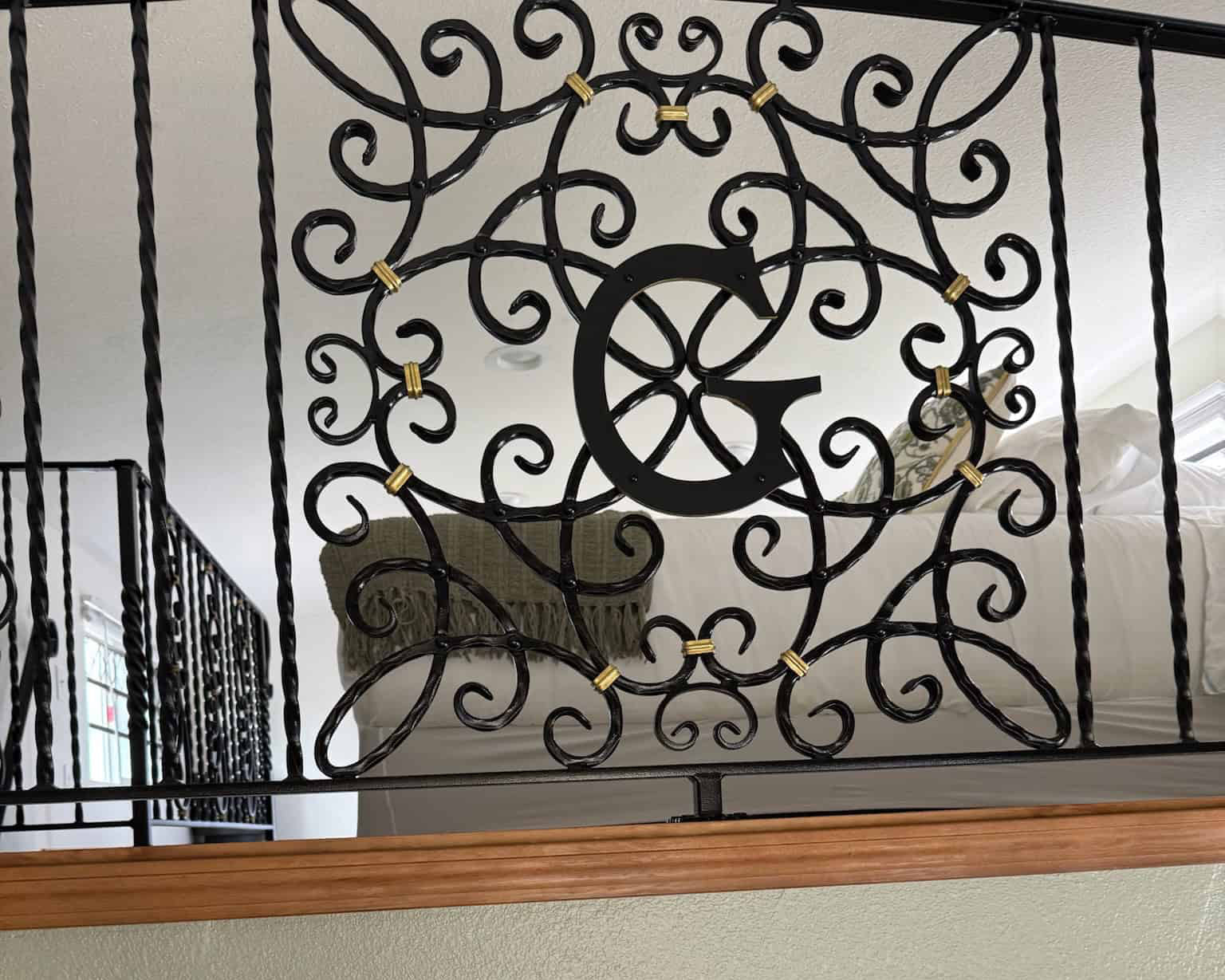 Custom Branded Metal Baluster on loft master bedroom overlooking kitchen