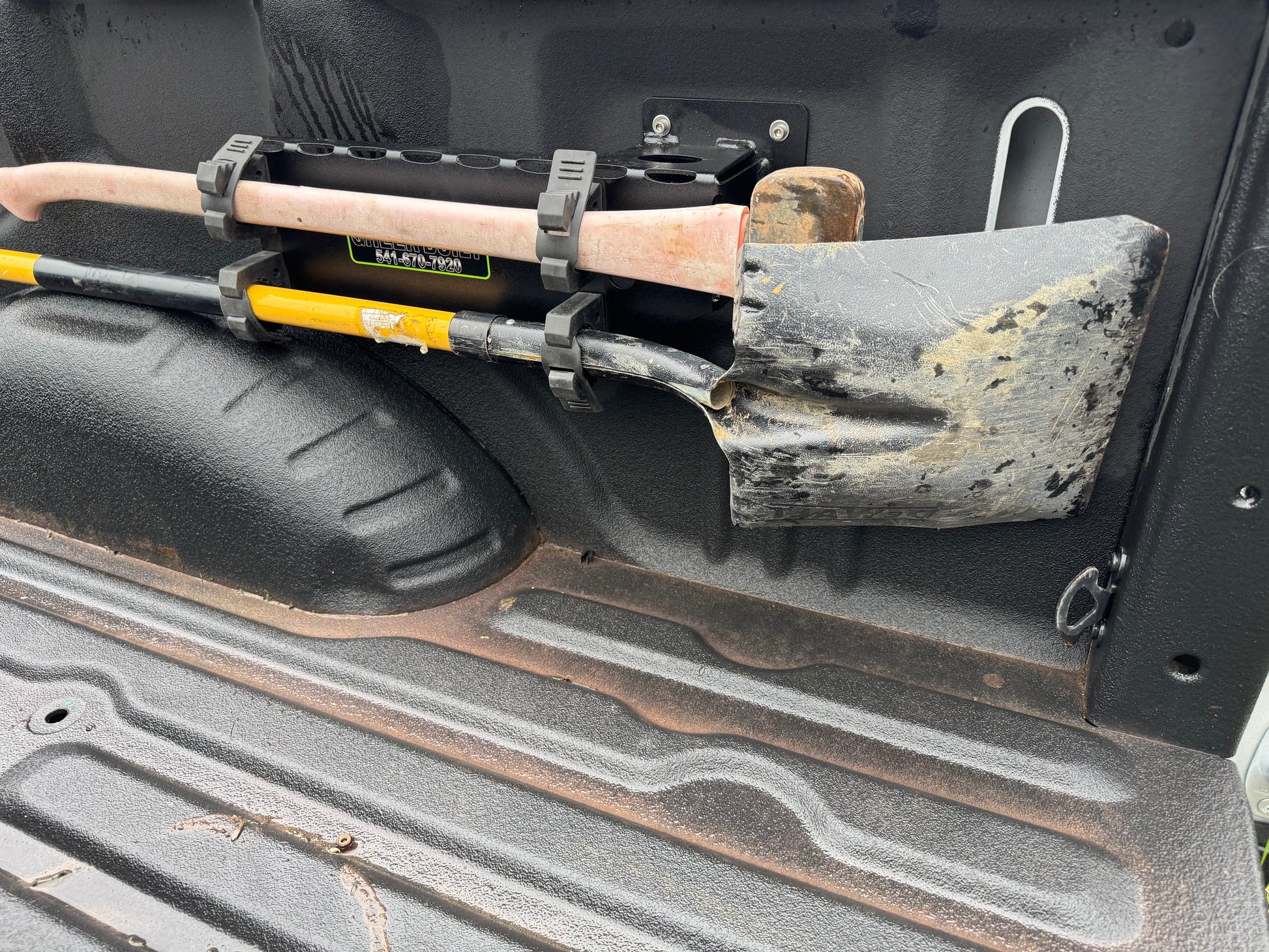 “Fire tool securely held in truck mount bracket”