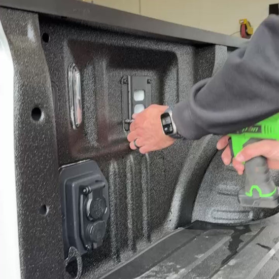 Man Installing quick release fire extinguisher holder on Ford truck