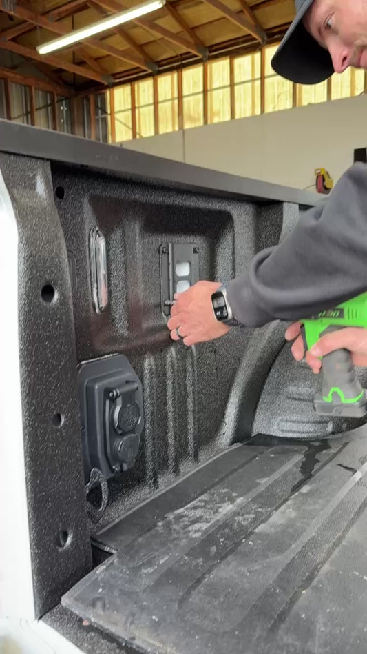 Man Installing quick release fire extinguisher holder on Ford truck